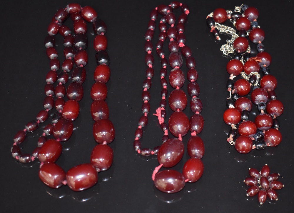 Three Cherry Amber Necklaces And A Cherry Amber Brooch. Sold For £480